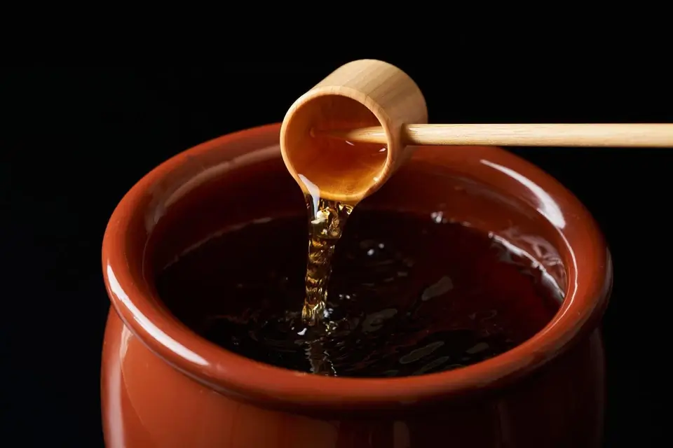 Traditional Kurozu brewing in earthenware jar